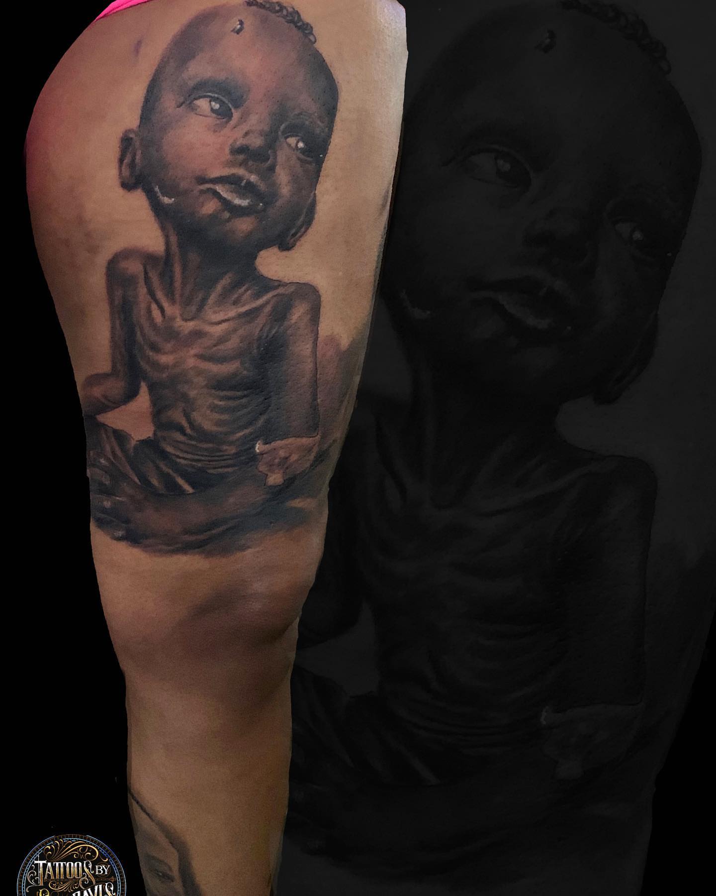 Starving child realism tattoo on the upper arm by Sly Davis