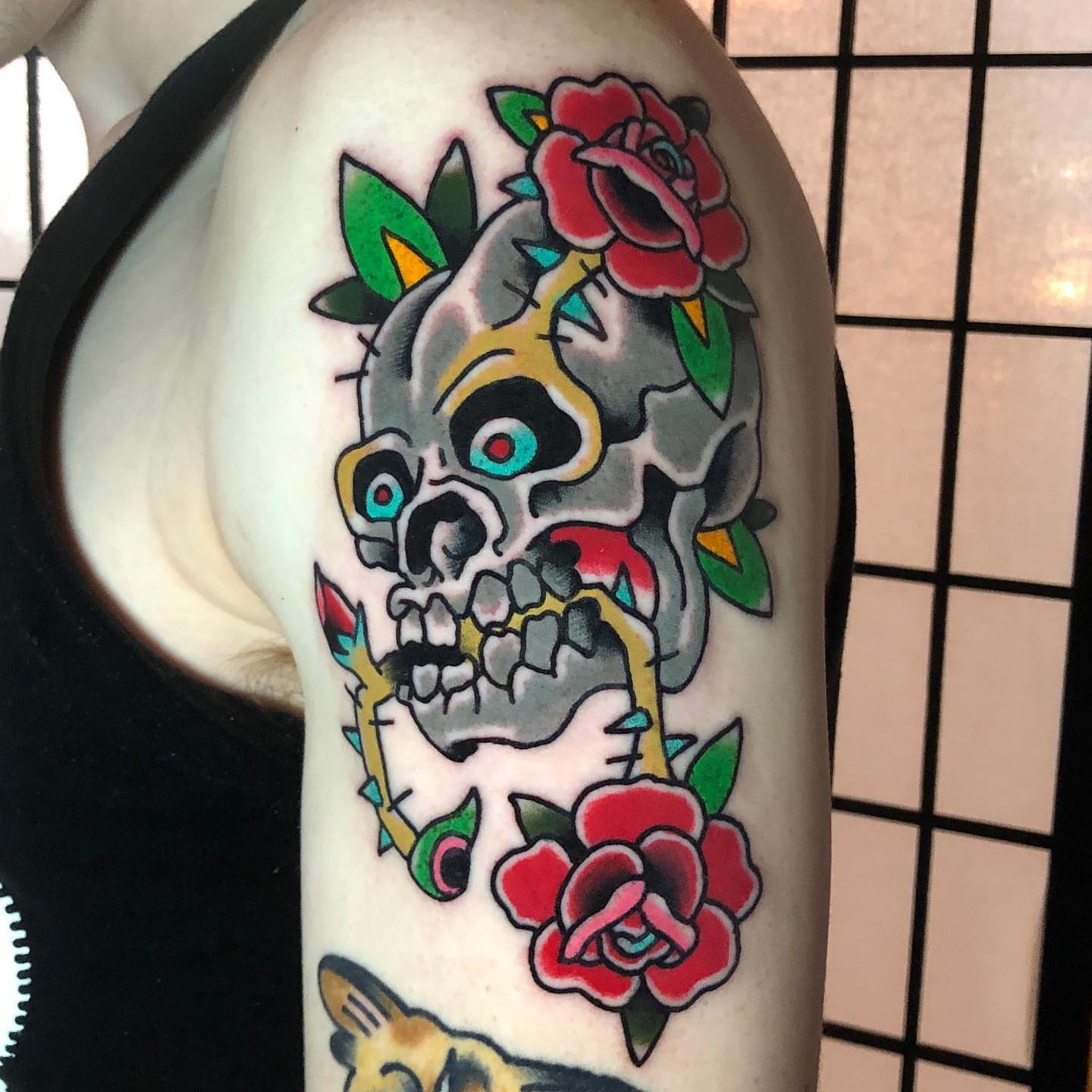 Skull and roses American traditional tattoo on the forearm by David Mendieta