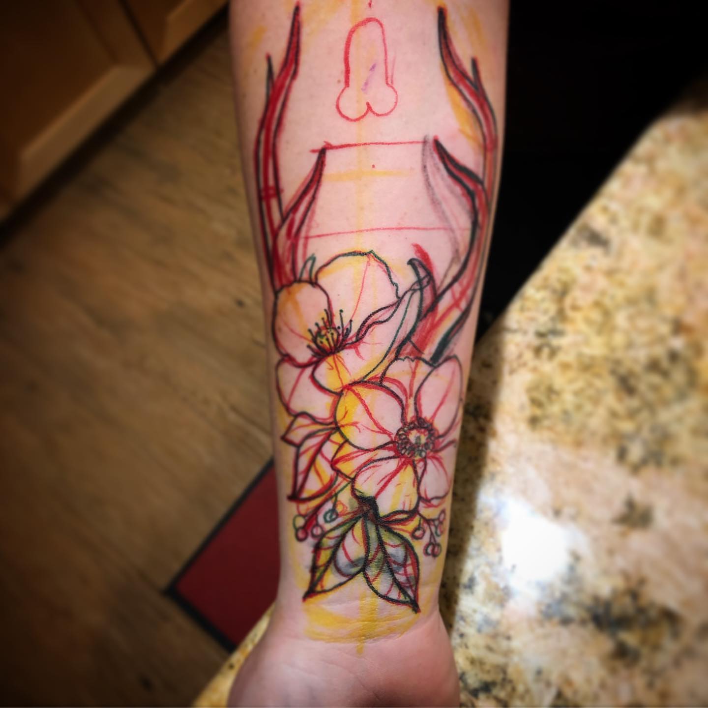 Flowers and antlers new school tattoo on the forearm by Dave Shurman