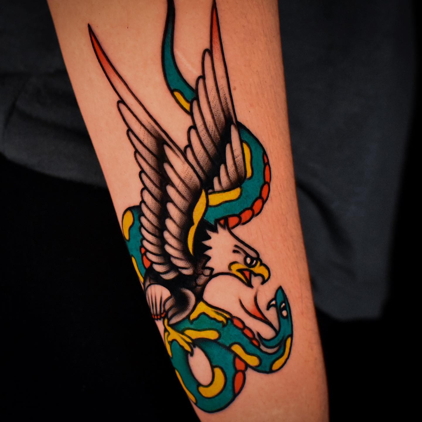 Eagle and snake American traditional tattoo on the forearm by Mario Arcila