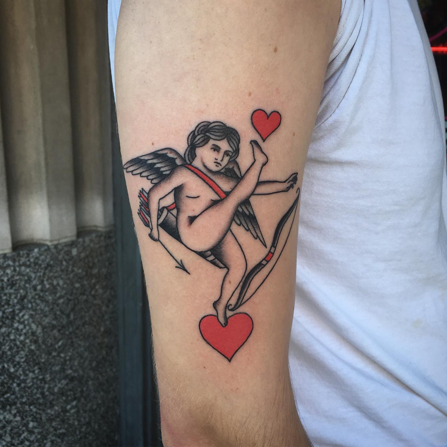 Cupid American traditional tattoo on the forearm by Paul Trimble