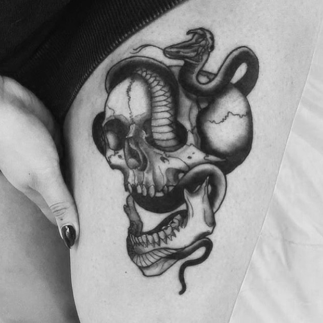 Skull with snake realism tattoo on the thigh by Sam Fortney, Columbus, Ohio