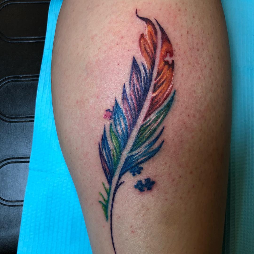 Feather watercolor tattoo on the thigh by KJ