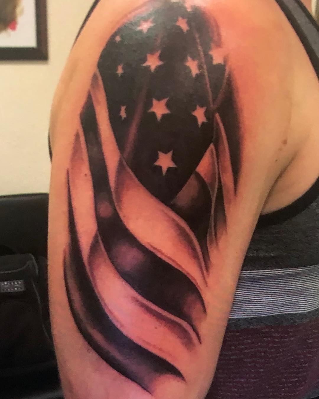 American flag black and grey tattoo on the shoulder by KJ