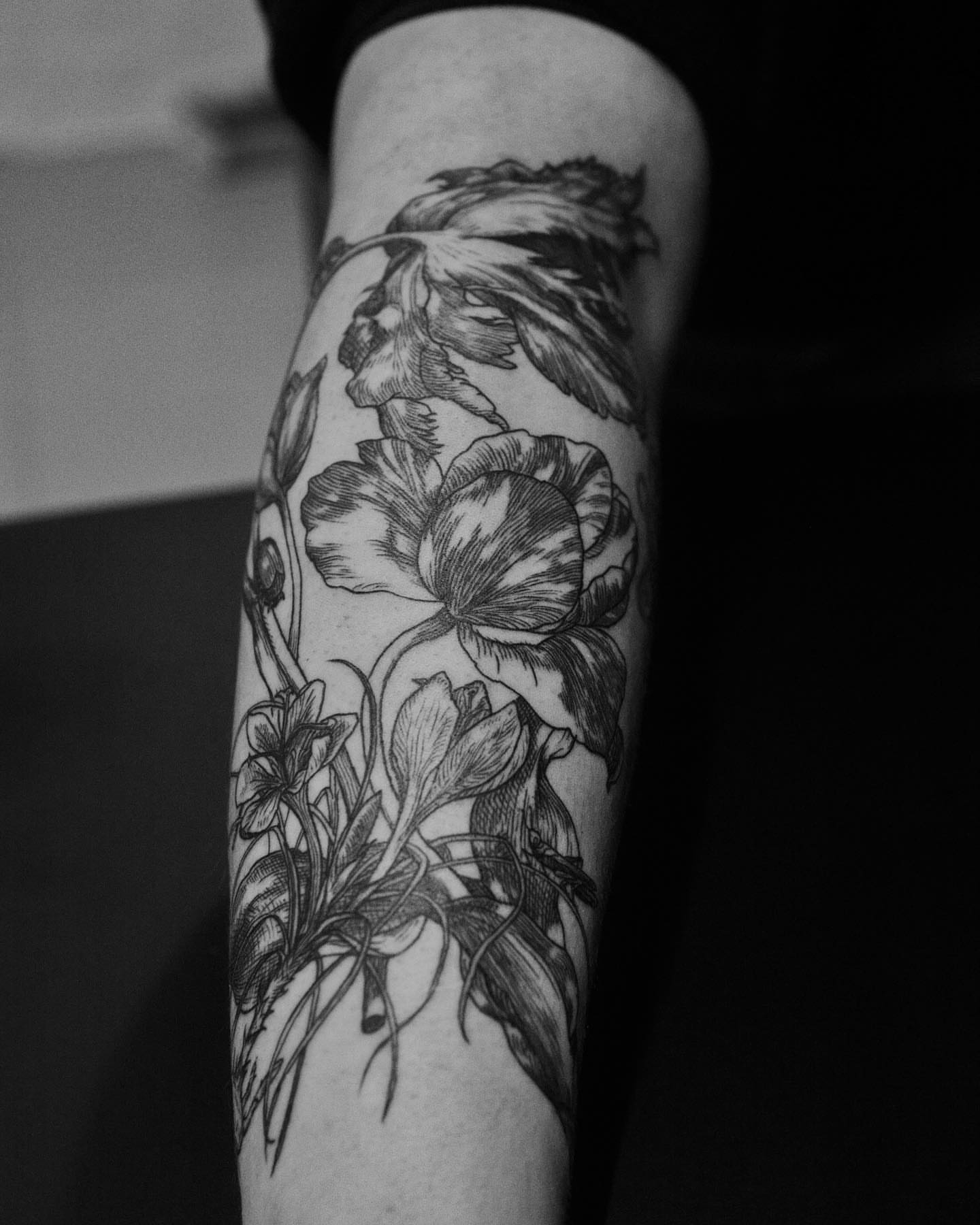 Floral bouquet realism tattoo on the forearm by Jorge Nox