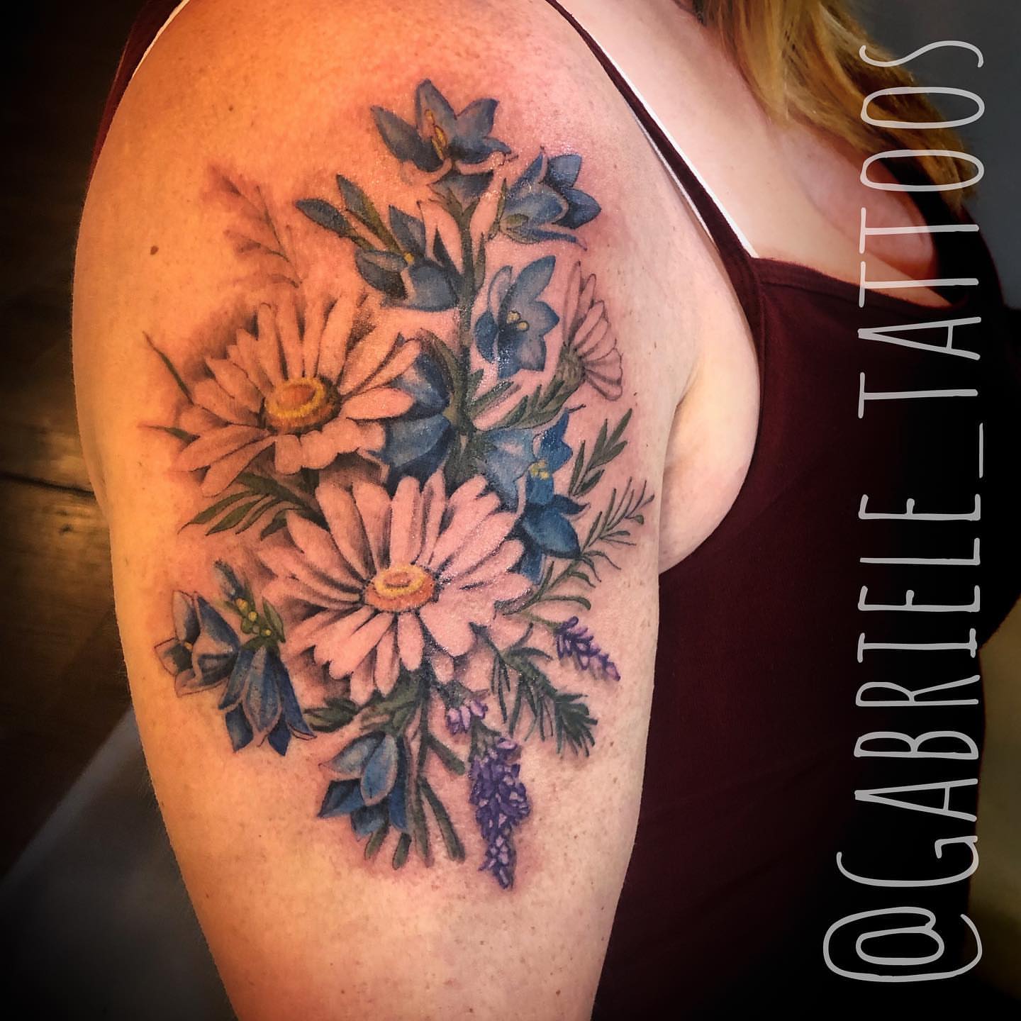 Flower bouquet realism tattoo on the shoulder by GABRIELExTATTOOS