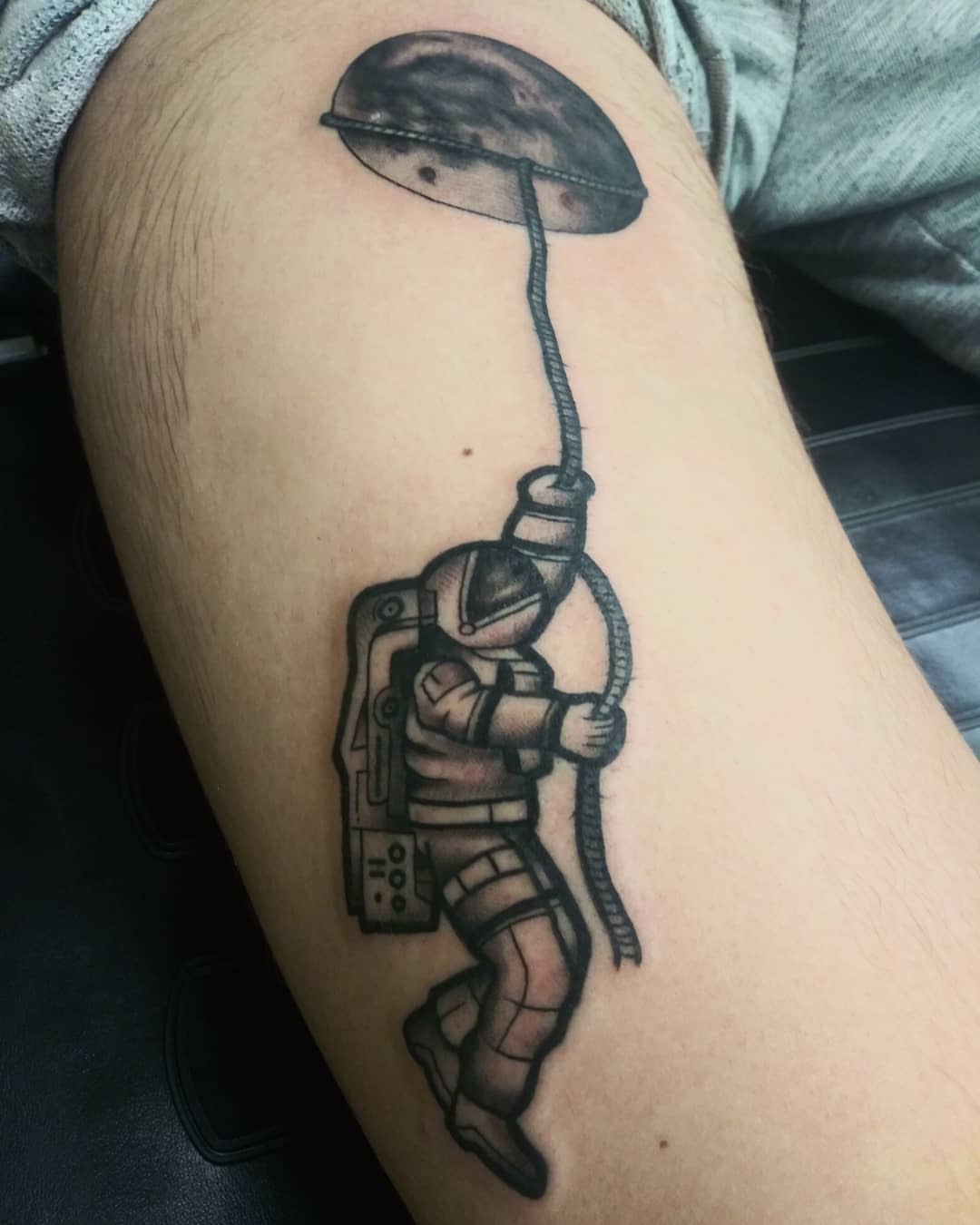 Astronaut with UFO black and grey tattoo on the thigh by Herc