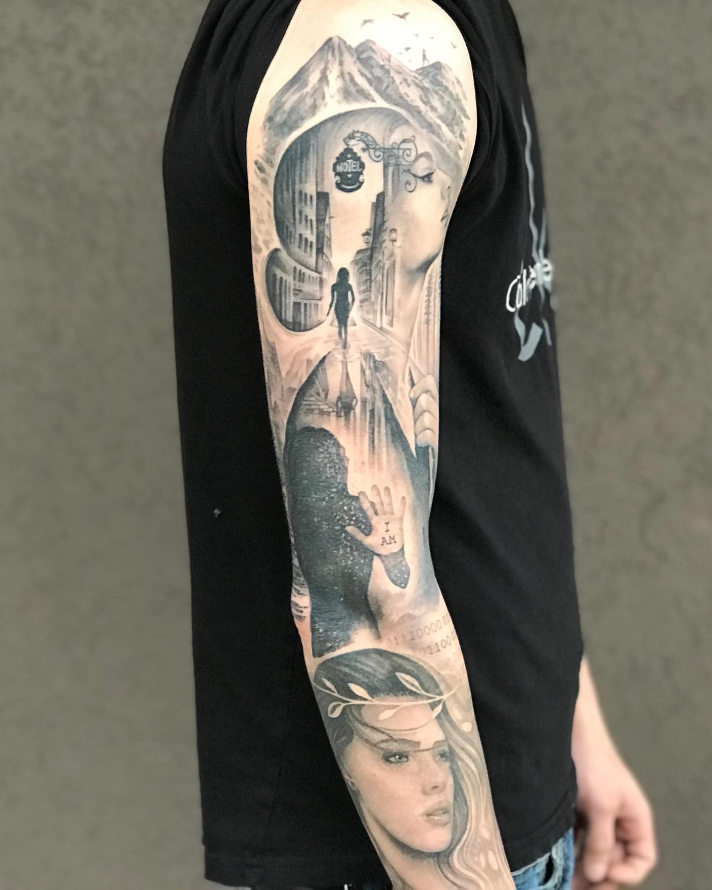 Cityscape and woman realism tattoo on the forearm by Jax Citriglia