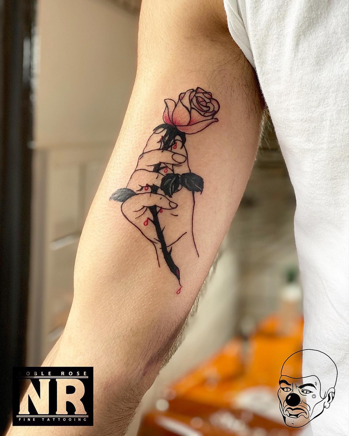 Hand holding rose fine line tattoo on the forearm by πππ πππππππ