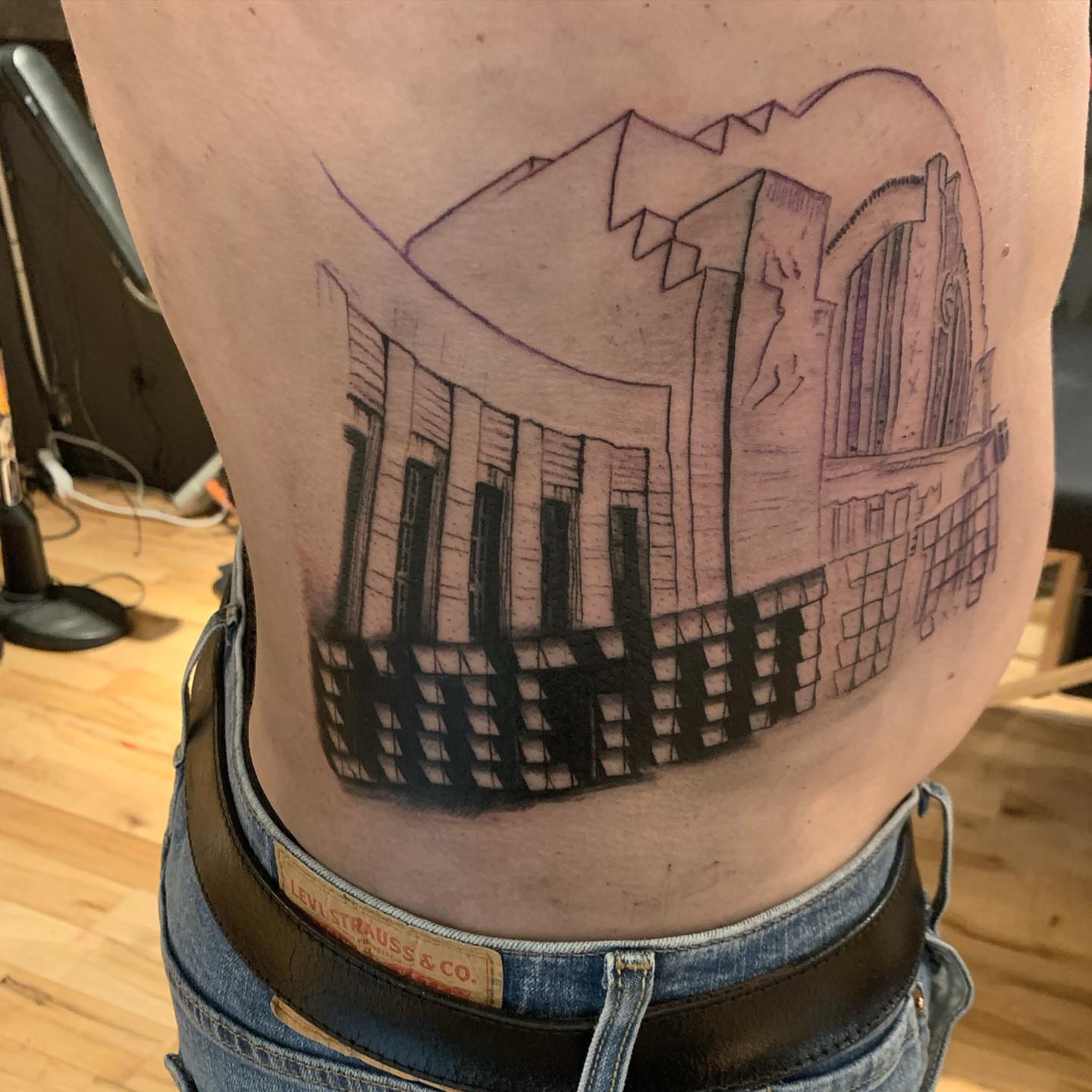 Building facade black and grey tattoo on the thigh by Jeff Kees