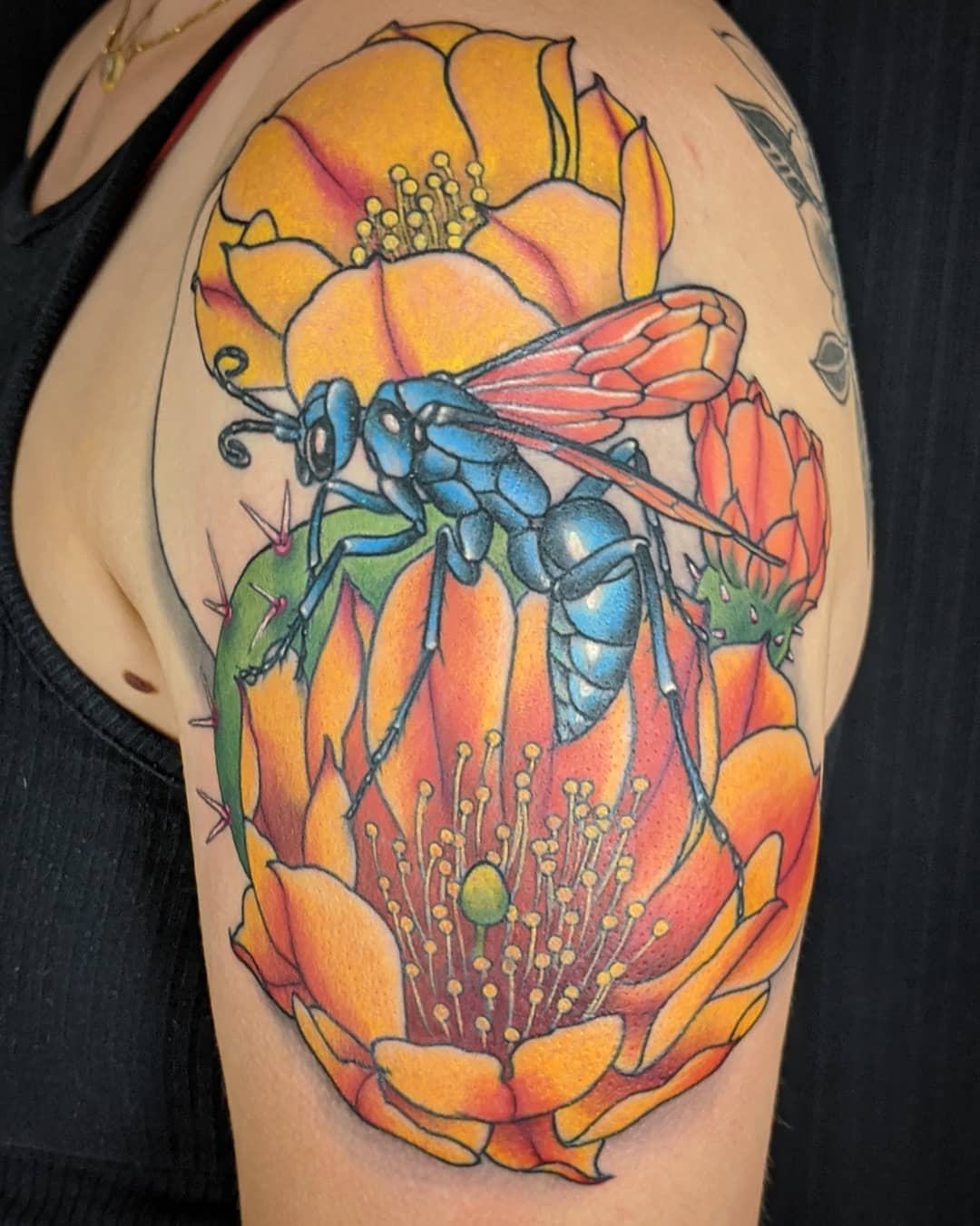 Wasp and cactus flower realism tattoo on the shoulder by Christel Perkins