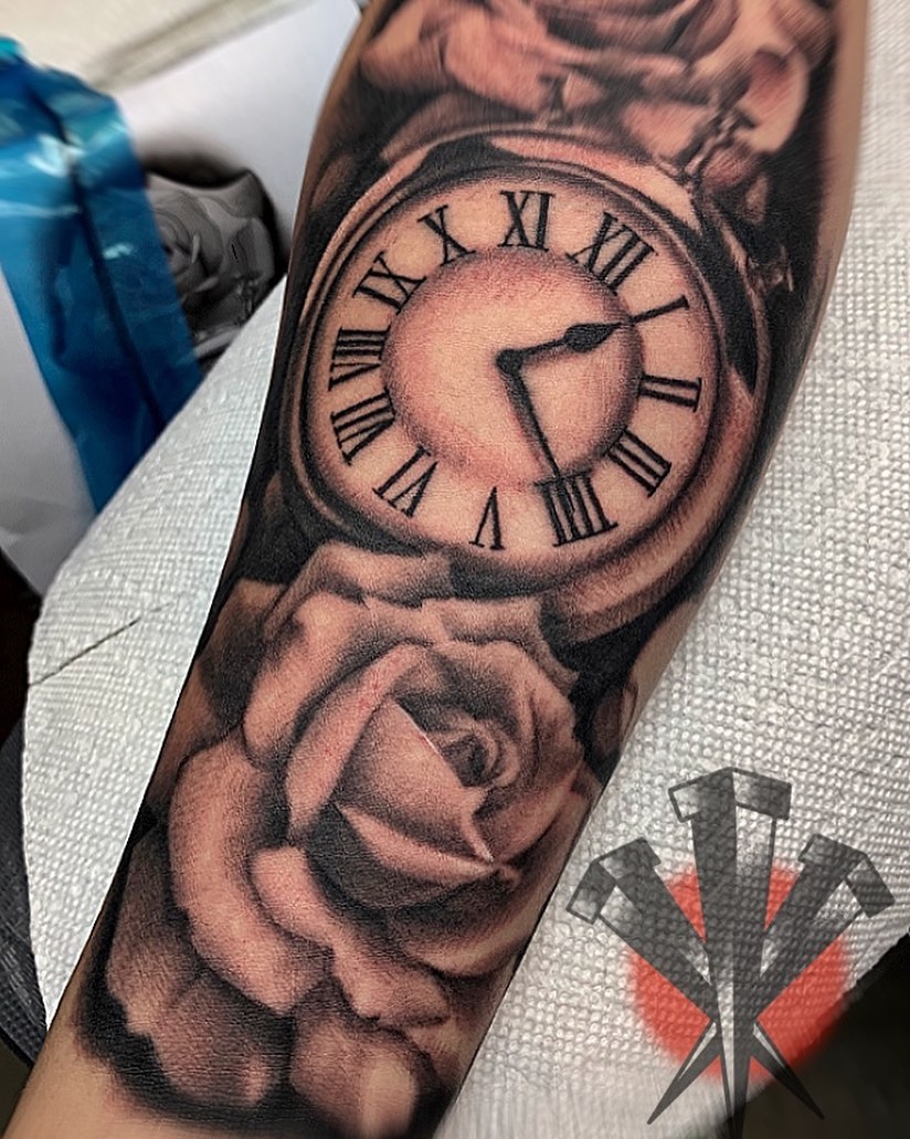 Clock and roses realism tattoo on the forearm by George Weibe
