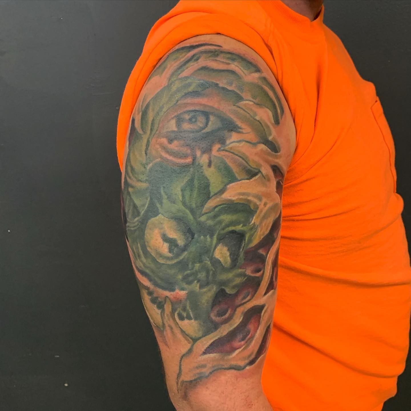 Eye and floral realism tattoo on the forearm by Jeff Kees