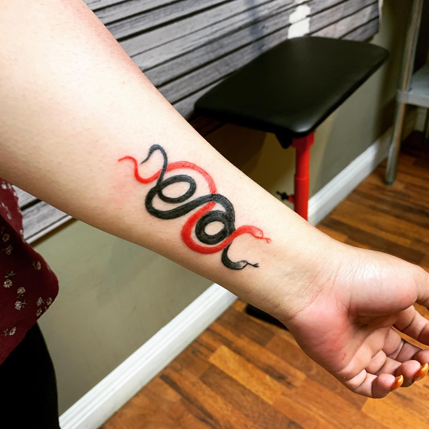 Serpent geometric tattoo on the forearm by Rhonda Faber Green