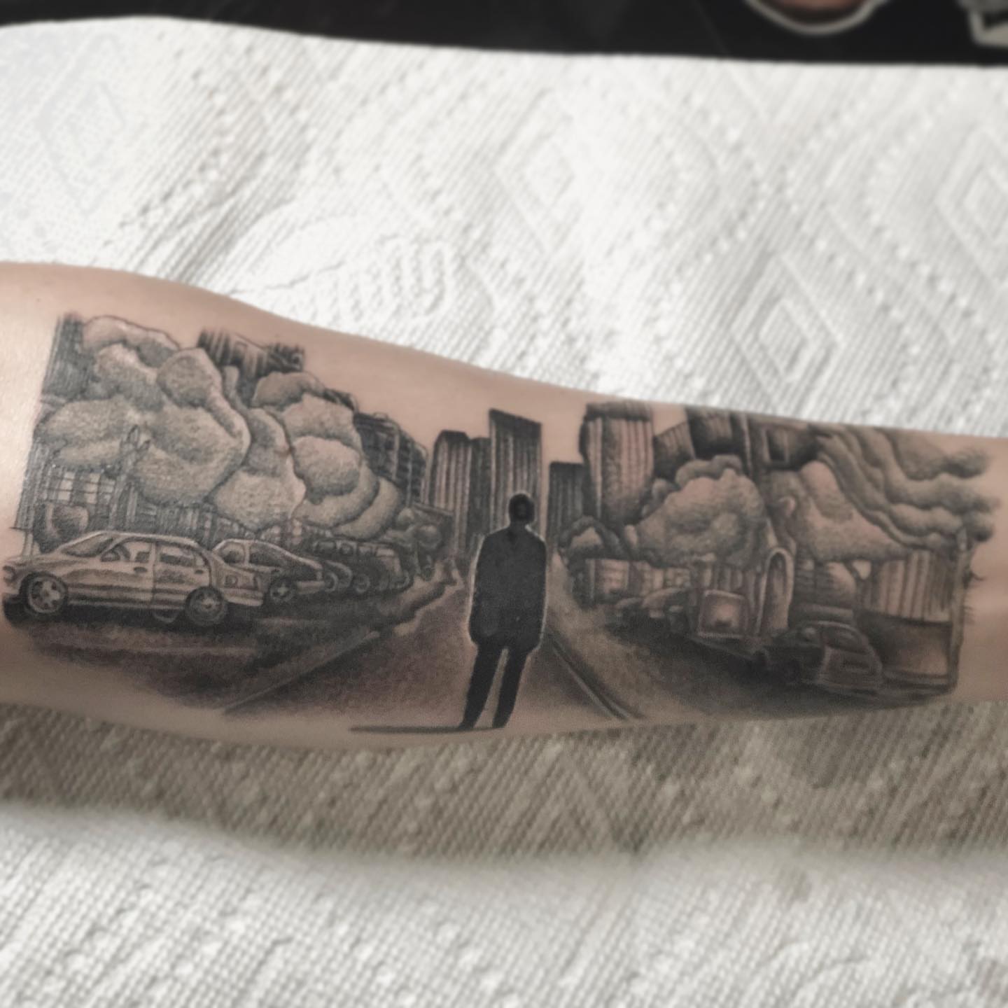 Cityscape realism tattoo on the forearm by Daniel Gutierrez