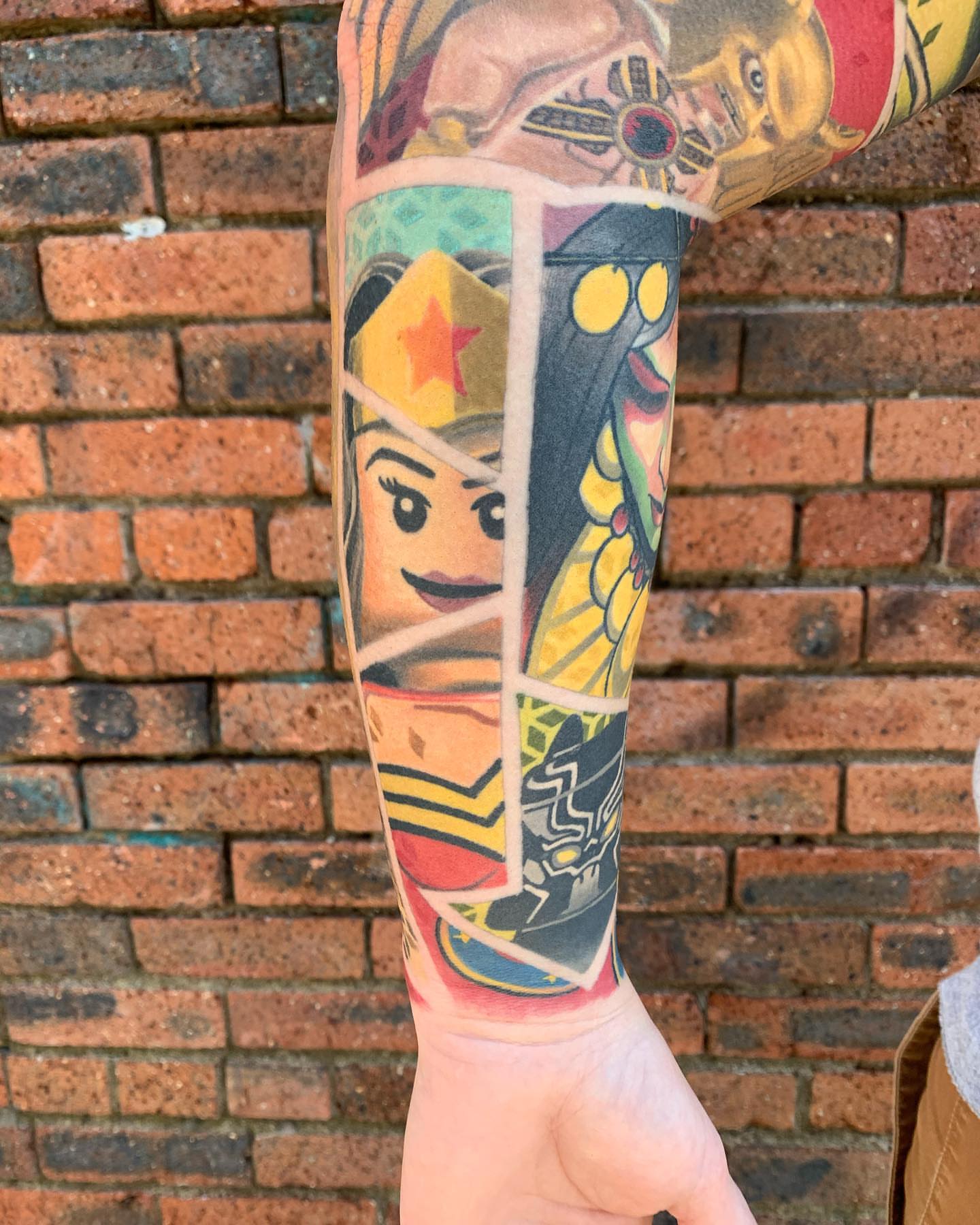 Wonder Woman and Batman American traditional tattoo on the forearm by Ben Viamontes