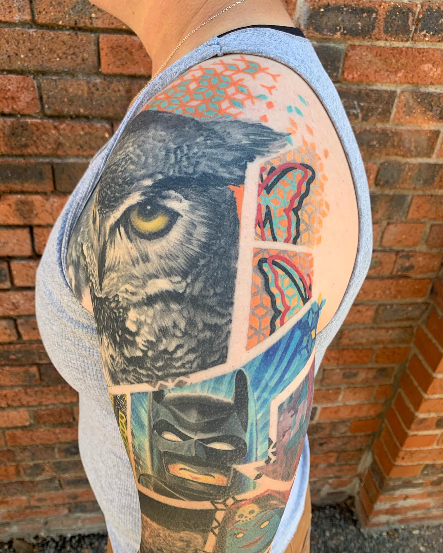 Owl and batman realism tattoo on the shoulder by Ben Viamontes