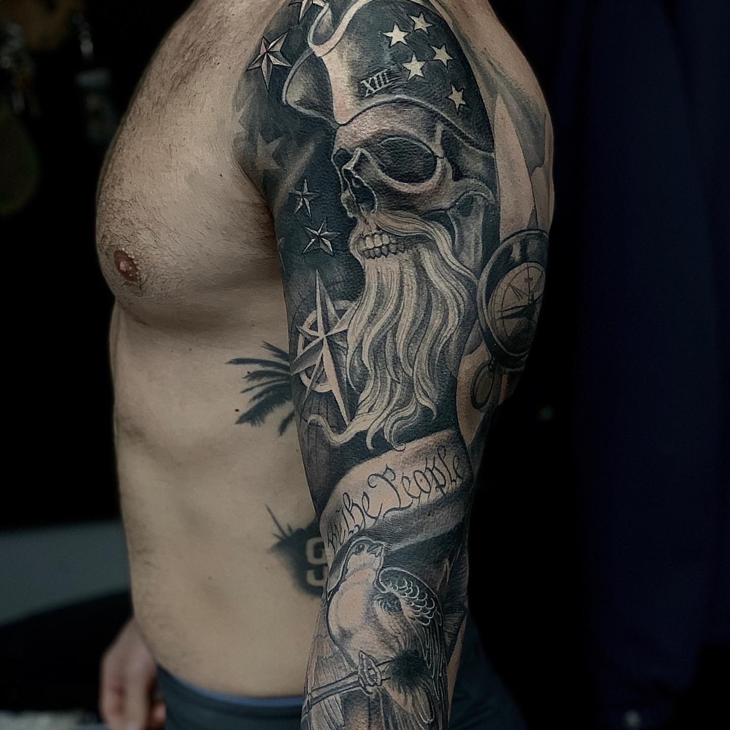 Skull with beard realism tattoo on the upper arm by Vinny Holistic Ink