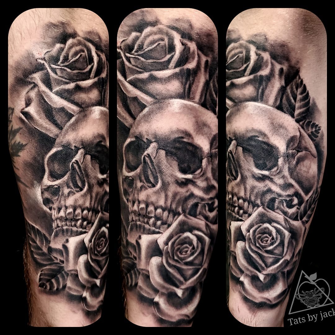 Skulls and roses realism tattoo on the forearm by Jack Daniel Knowlden