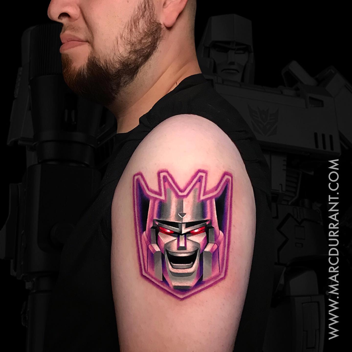 Decepticon geometric tattoo on the shoulder by ᴍᴀʀᴄ ᴅᴜʀʀᴀɴᴛ, Los Angeles, California
