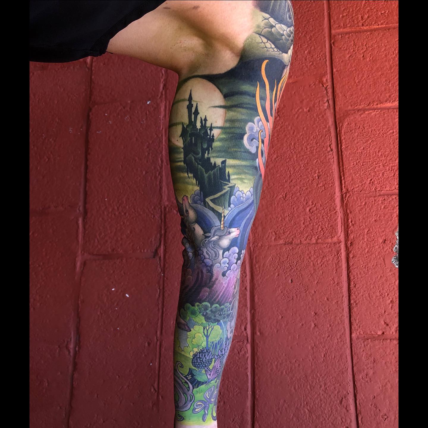Fantasy landscape new school tattoo on the upper arm by Erin Chance