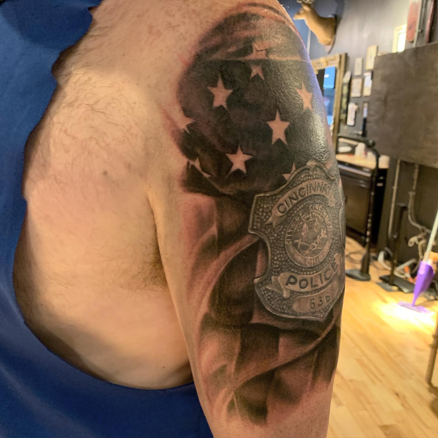 Police badge realism tattoo on the shoulder by Jeff Kees
