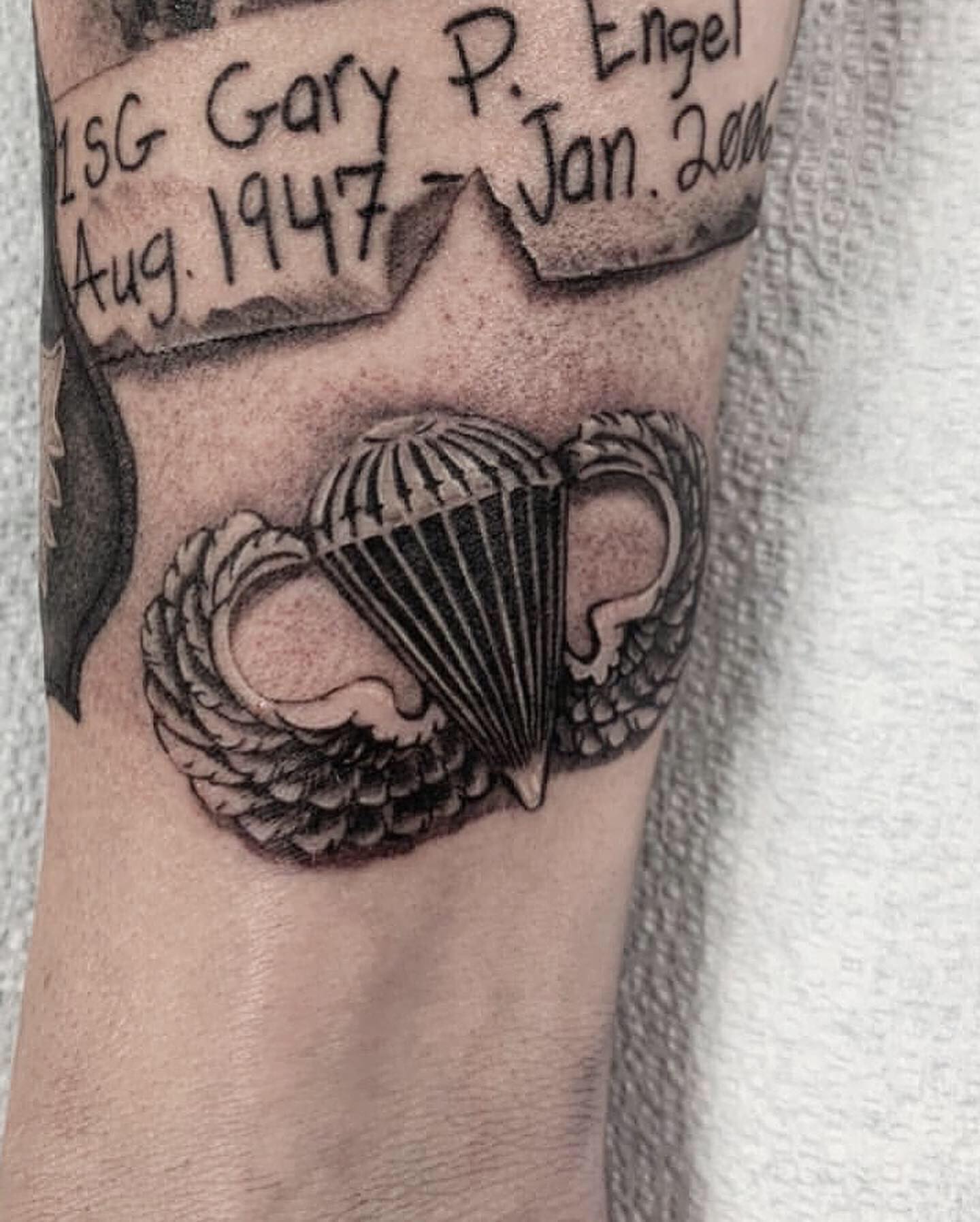 Parachute wings black and grey tattoo on the forearm by Adrian Dominguez, Las Vegas, Nevada