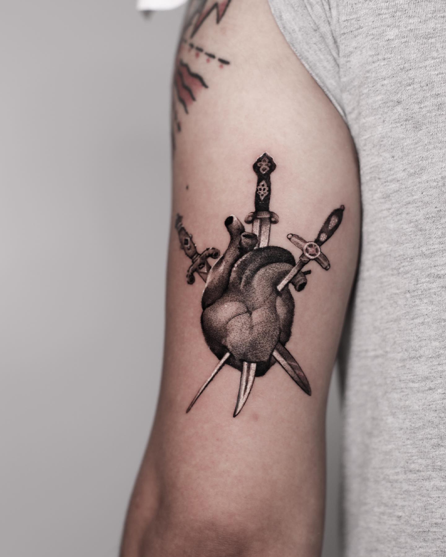 Heart with swords dotwork tattoo on the forearm by Anna Chernova, San Francisco, California