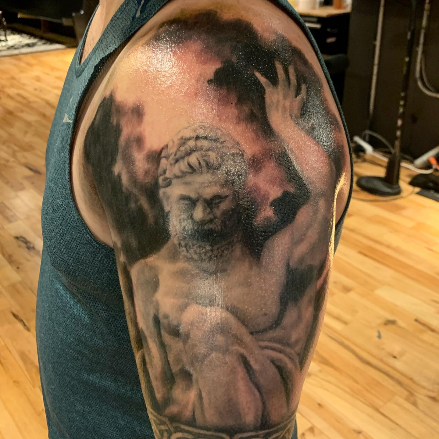 Statue of a bearded man realism tattoo on the shoulder by Jeff Kees