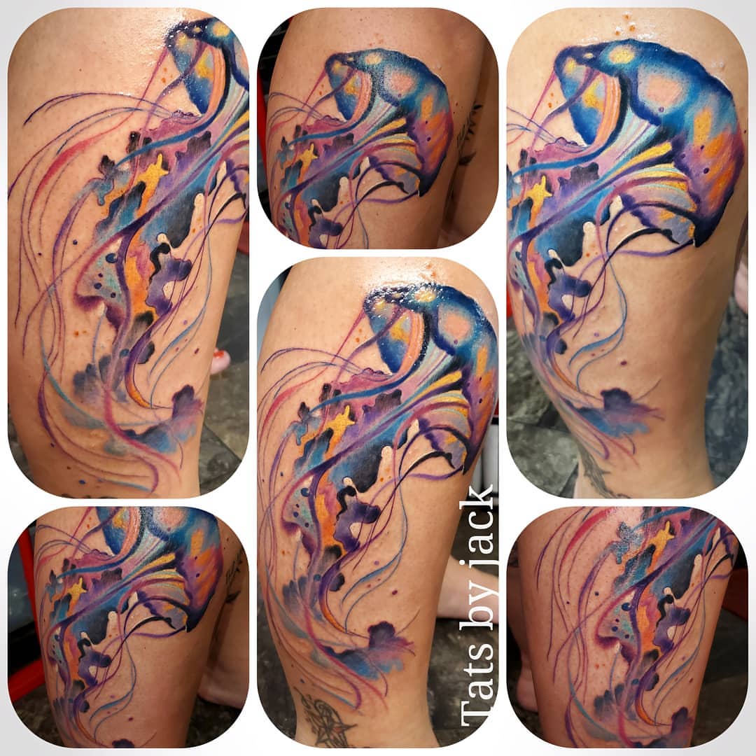 Jellyfish watercolor tattoo on the thigh by Jack Daniel Knowlden