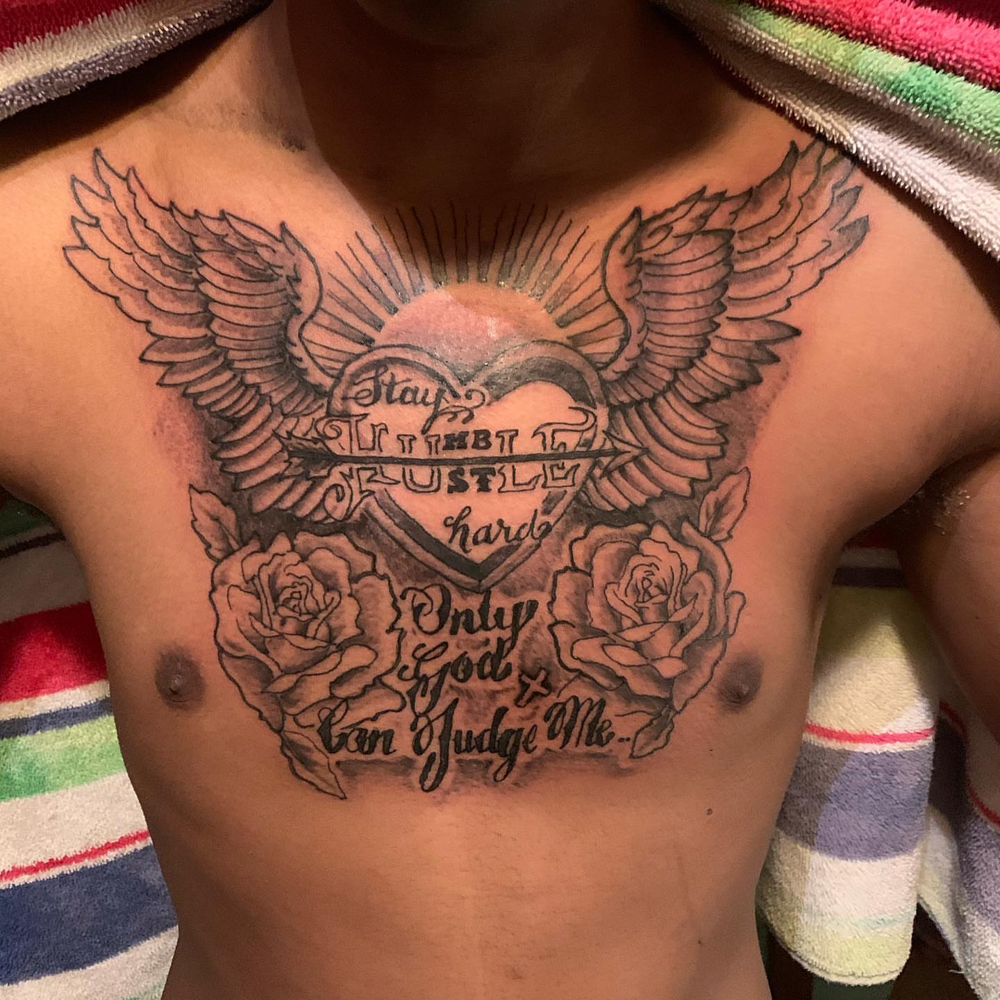 Heart with wings American traditional tattoo on the chest by Deangelo Inkcrazy Dukes