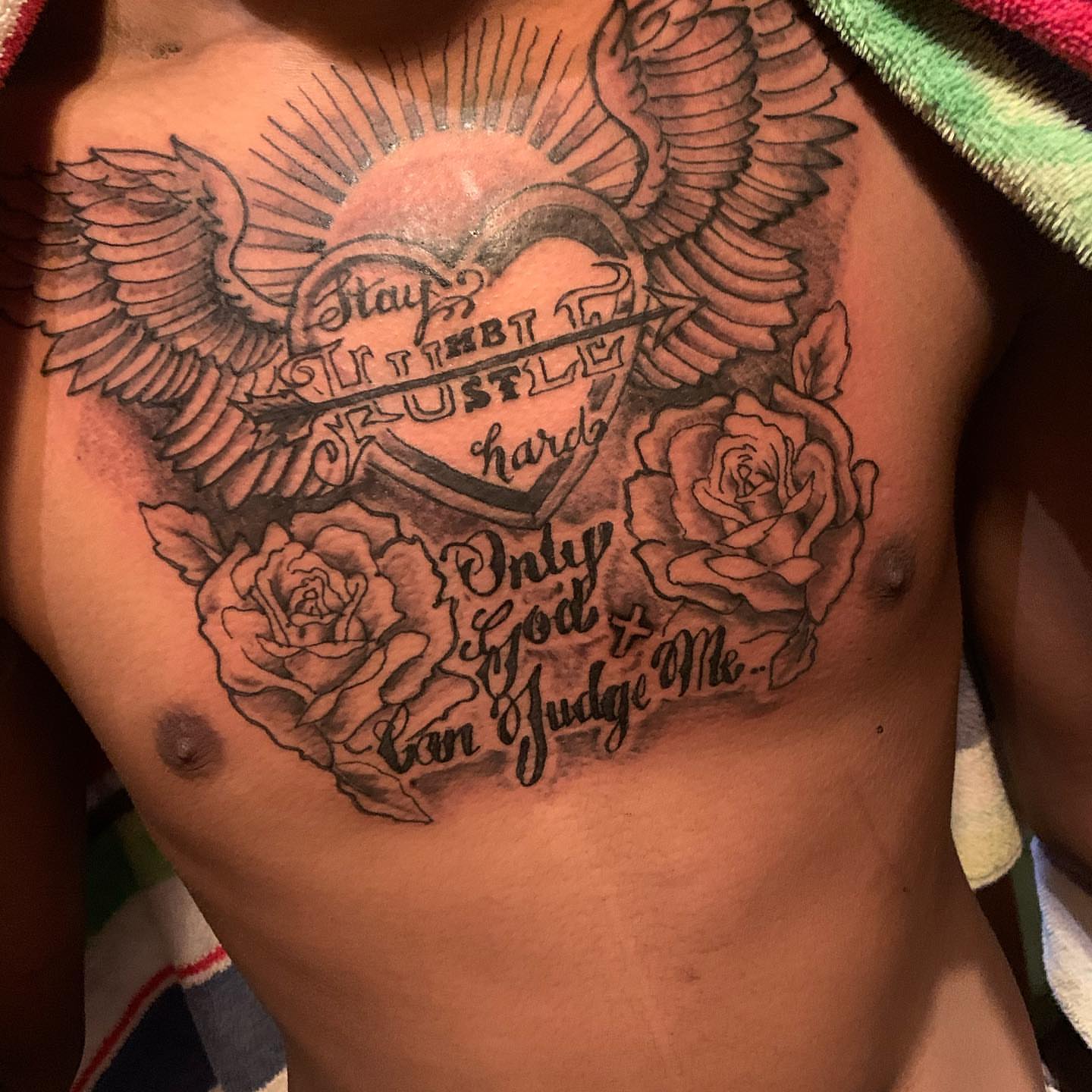 Heart with wings and roses black and grey tattoo on the chest by Deangelo Inkcrazy Dukes