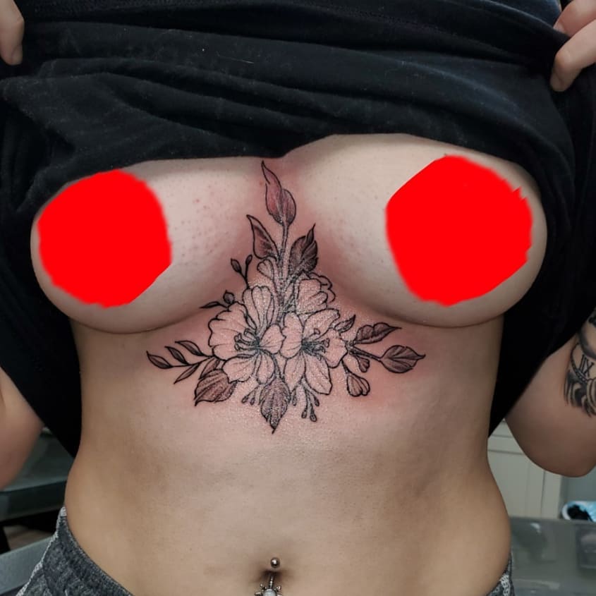 Floral arrangement black and grey tattoo on the chest by André Brazil