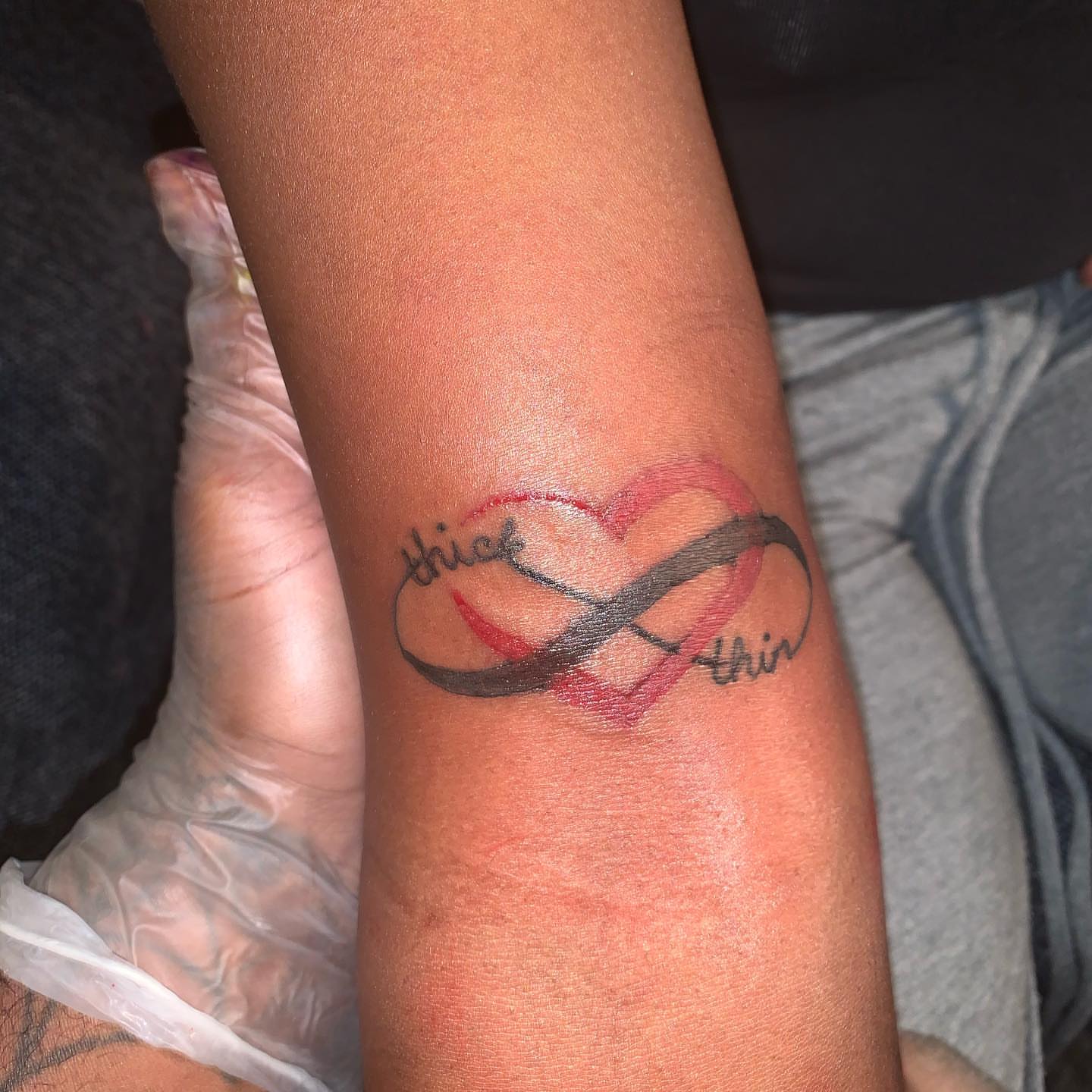 Heart with infinity symbol lettering script tattoo on the forearm by Deangelo Inkcrazy Dukes