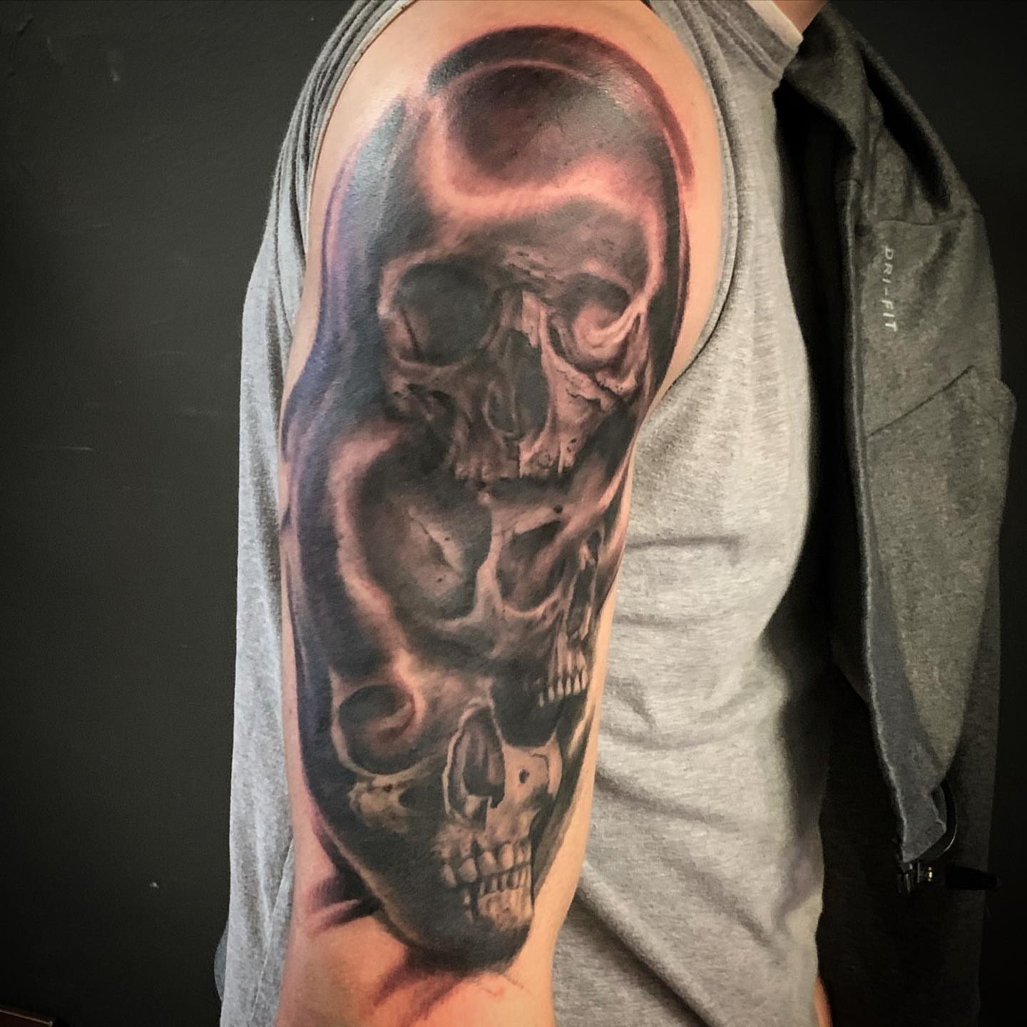 Skull realism tattoo on the upper arm by Jeff Kees