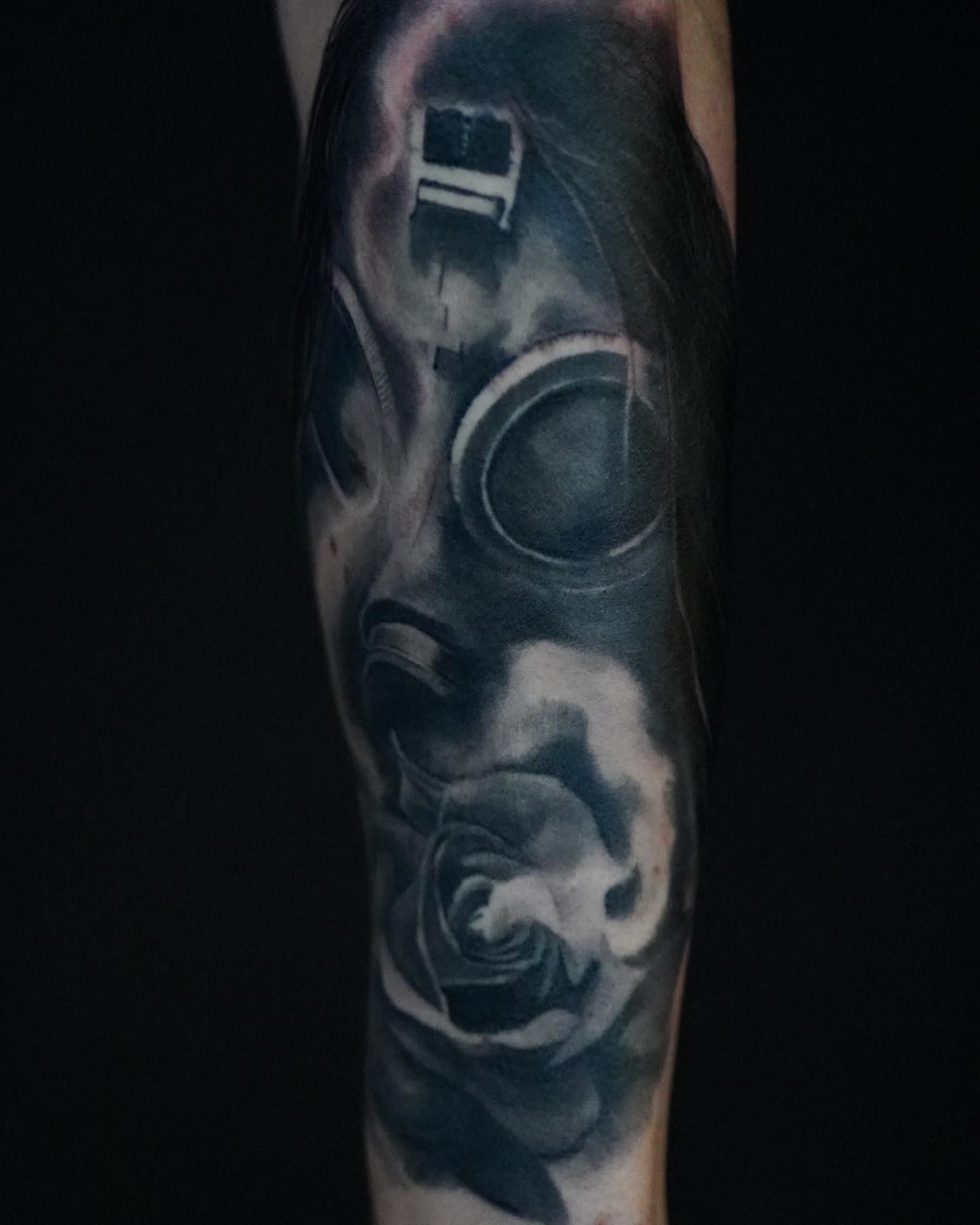 Gas mask and rose realism tattoo on the forearm by Jeff Kees