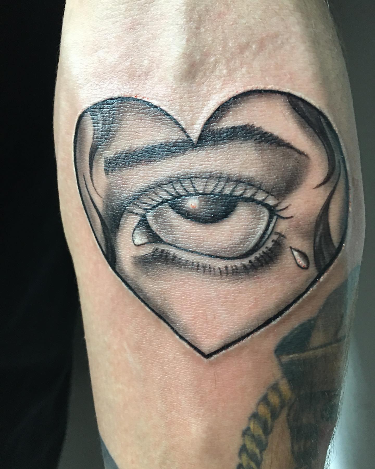 Eye within heart realism tattoo on the forearm by ATLANTA Queer Tattooer