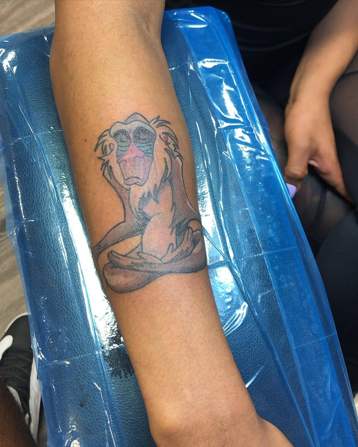 Lion black and grey tattoo on the forearm by Dre Inks