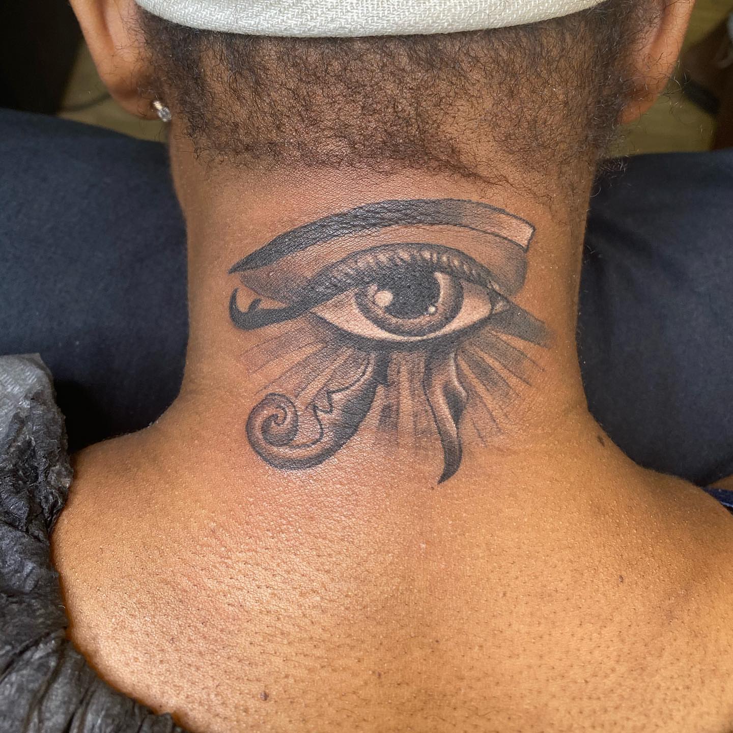 Eye black and grey tattoo on the neck by pecous