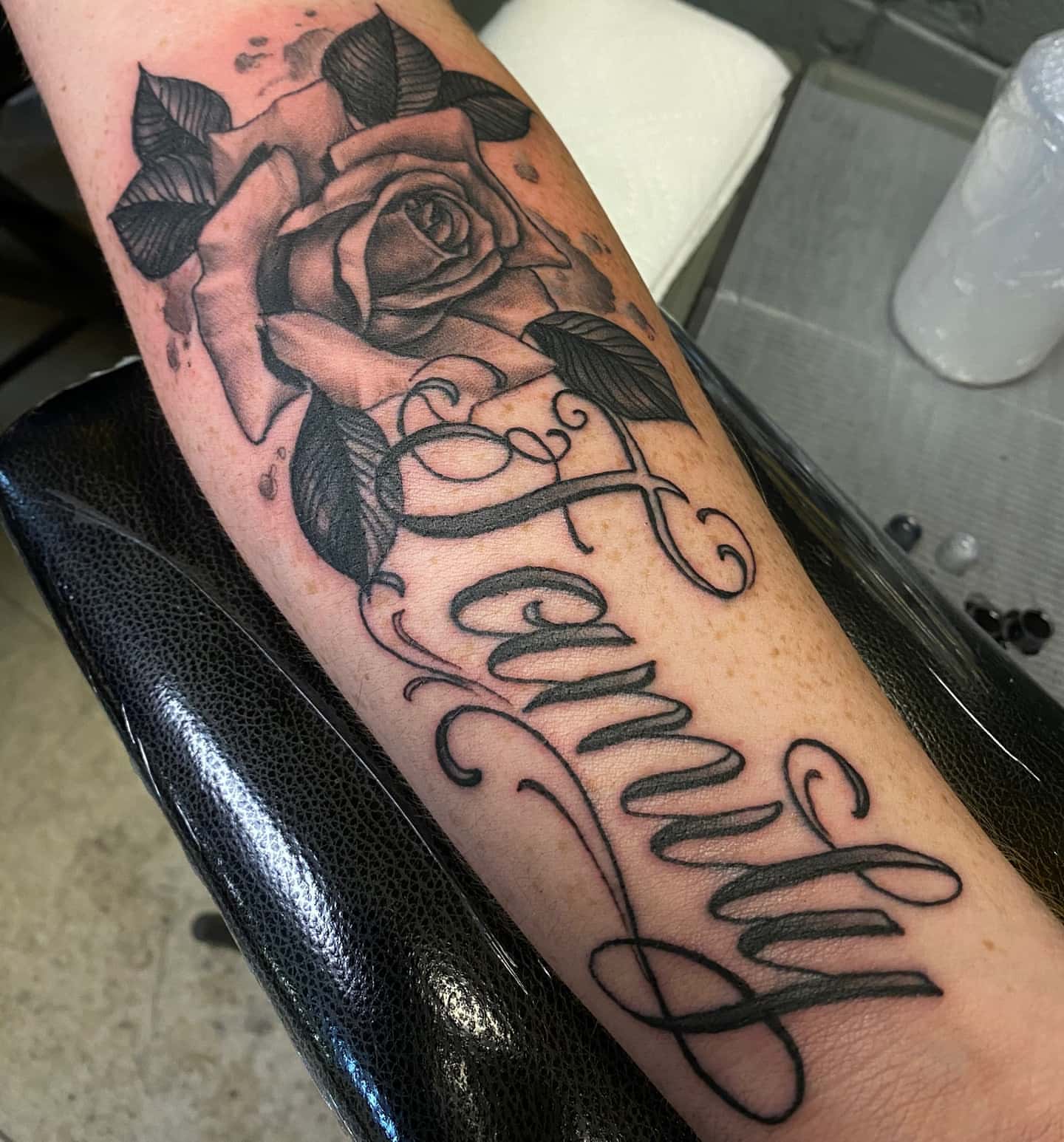 Rose and cursive realism tattoo on the forearm by Anthony Coleman, Midland, Texas