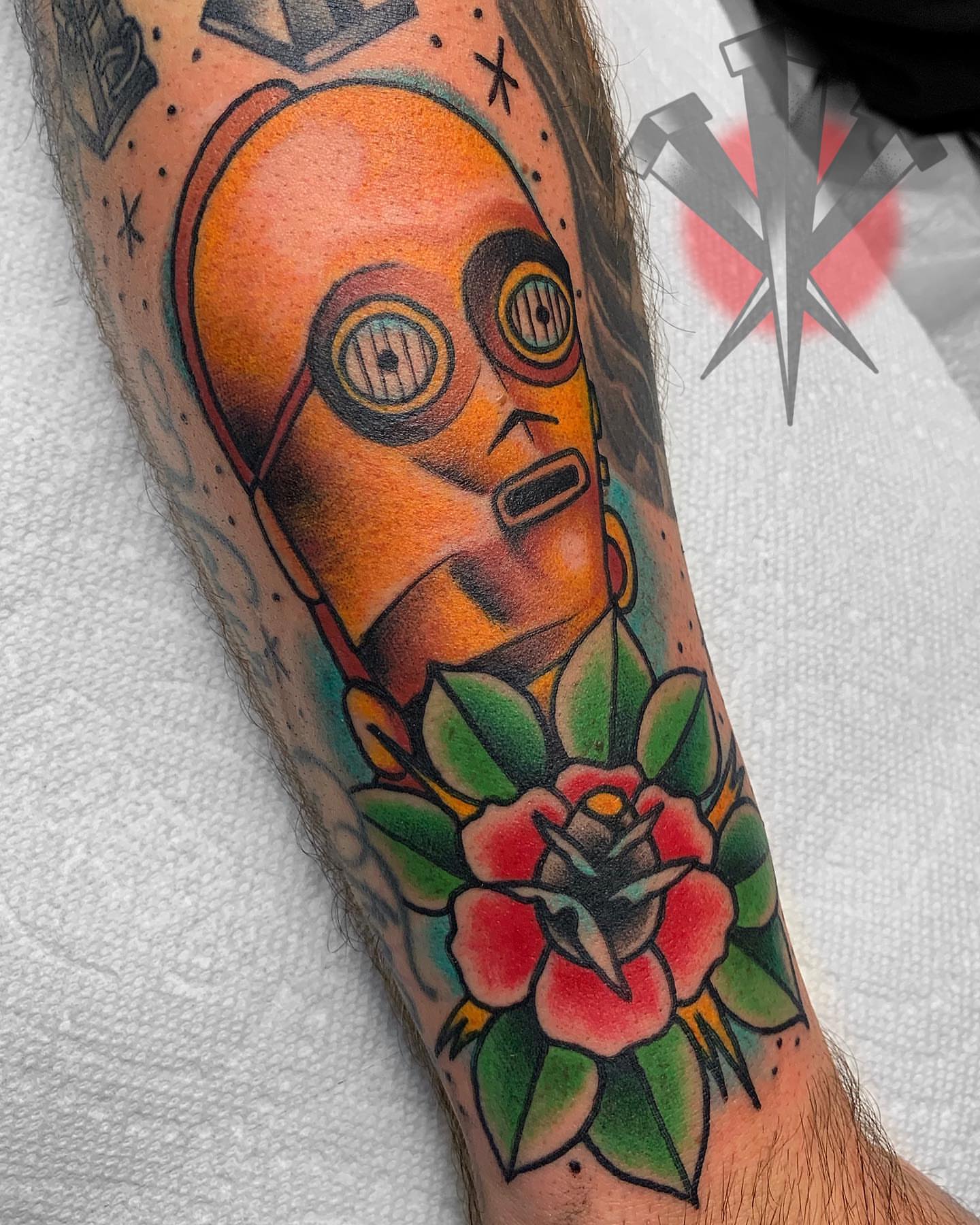 Robot head with flowers American traditional tattoo on the forearm by George Weibe
