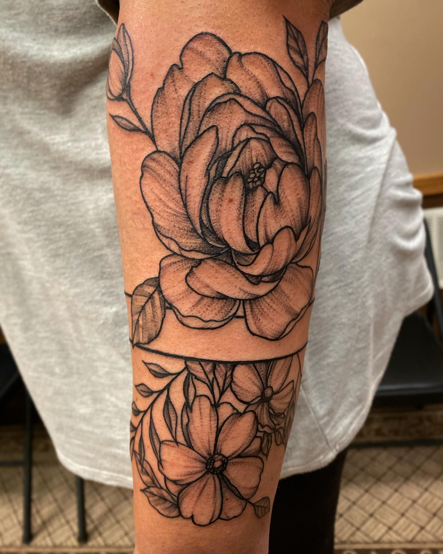 Peony black and grey tattoo on the forearm by mike hudson