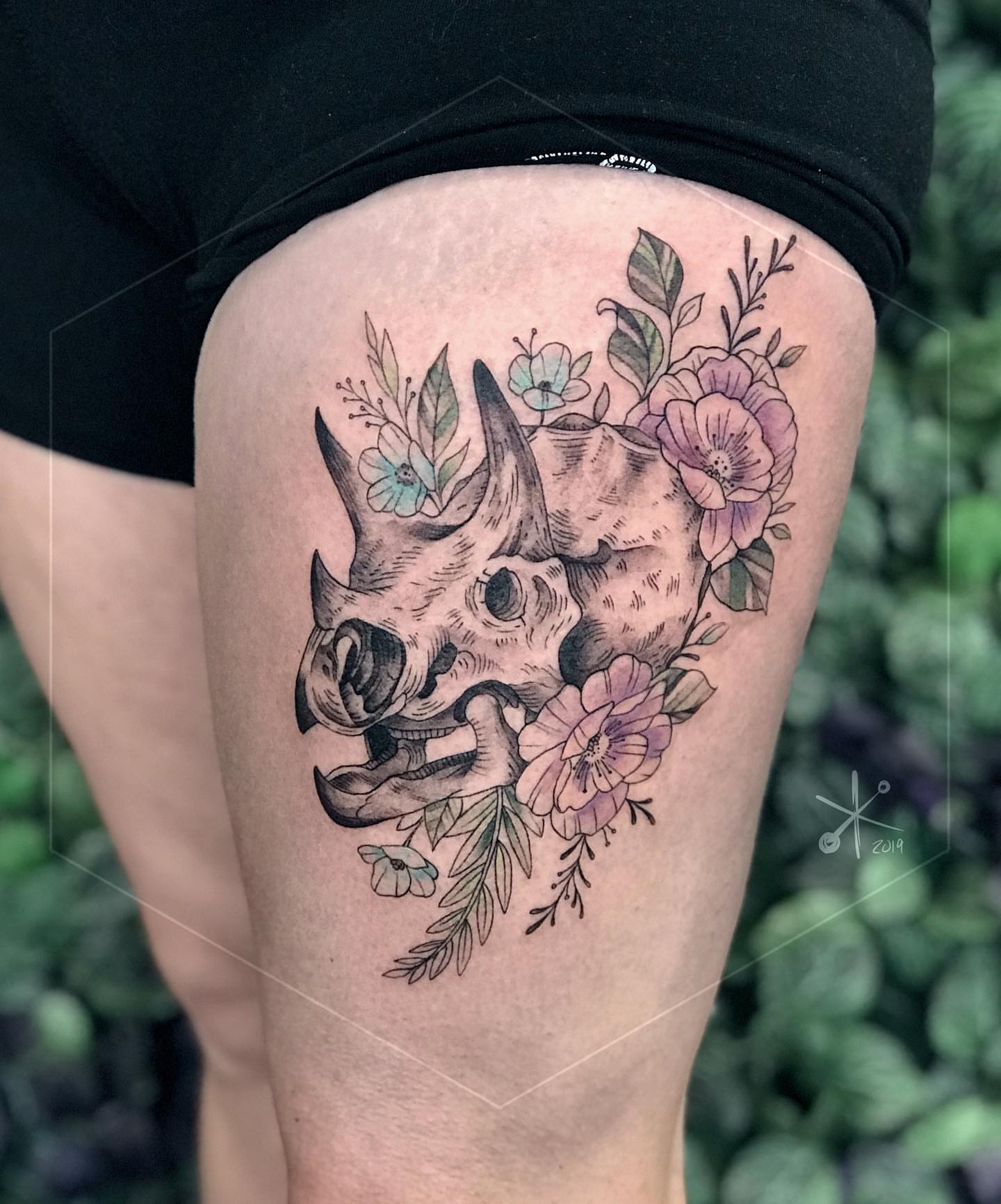 Rhino skull with flowers realism tattoo on the thigh by Jax Citriglia