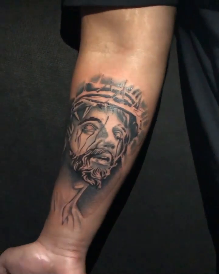 Jesus Christ portrait Chicano tattoo on the forearm by Tattoos By Mauze