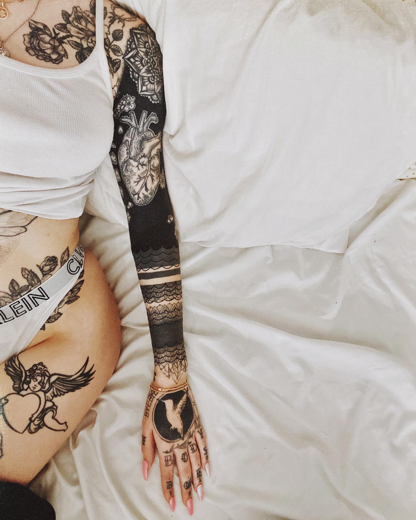 Heart with floral details American traditional tattoo on the upper arm by alexandra