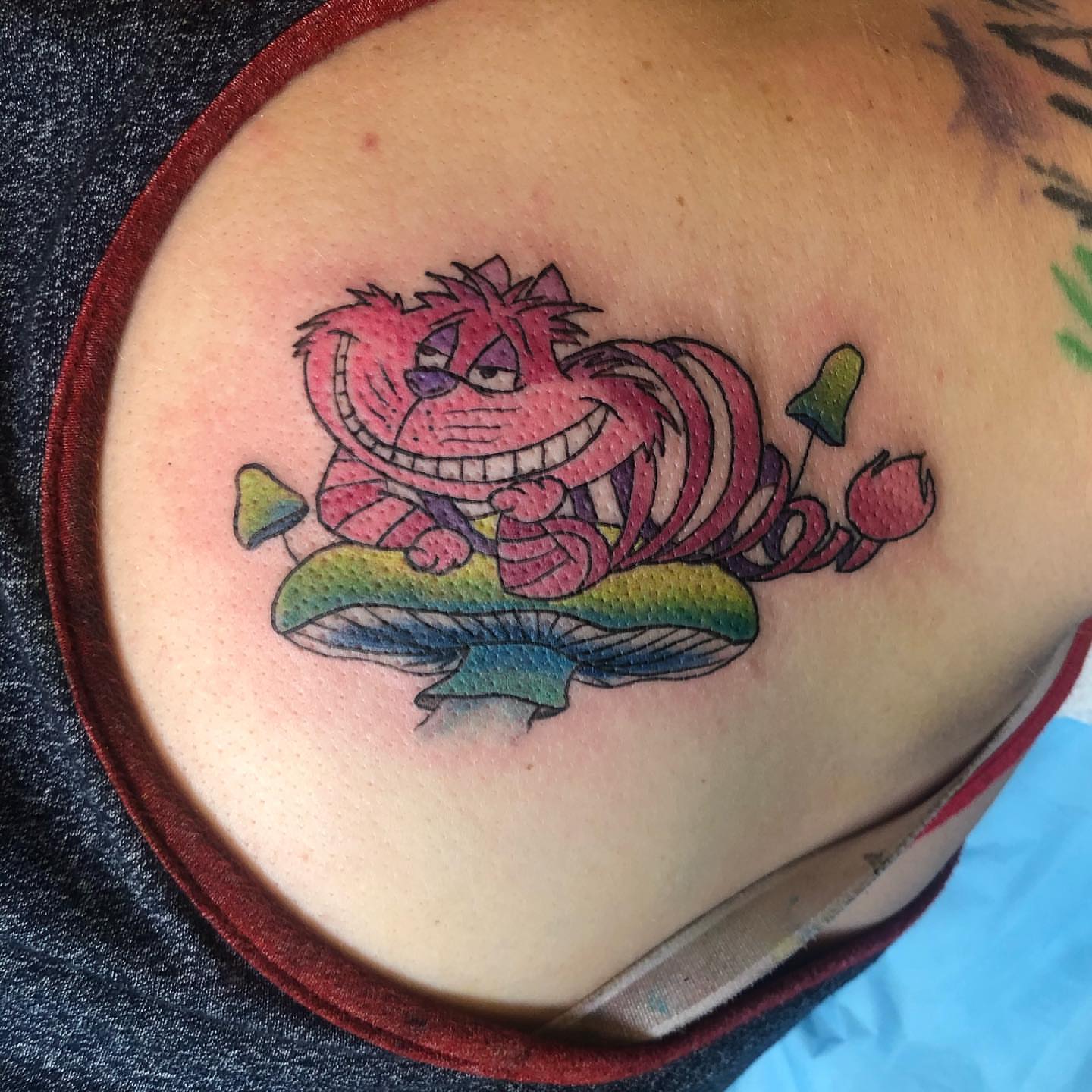 Cheshire cat new school tattoo on the shoulder by Sally Darling