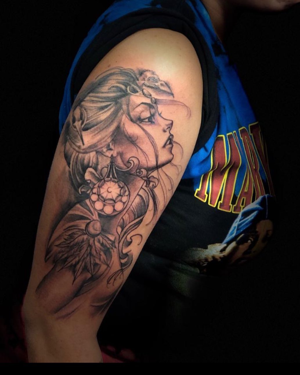 Woman's face realism tattoo on the upper arm by Mikeyftsk2