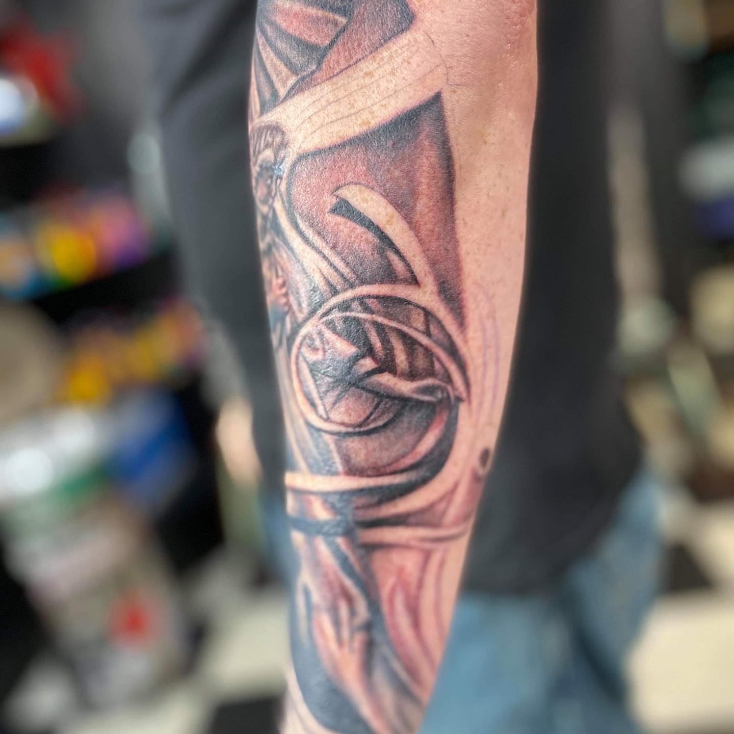 Astronaut helmet black and grey tattoo on the forearm by Brian Keith
