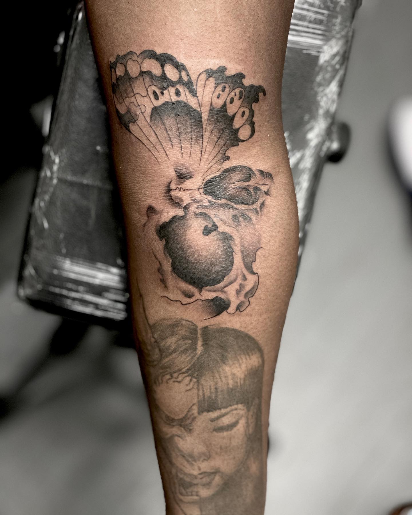 Butterfly and apple black and grey tattoo on the forearm by DJ ๐จ๐พโ๐จ