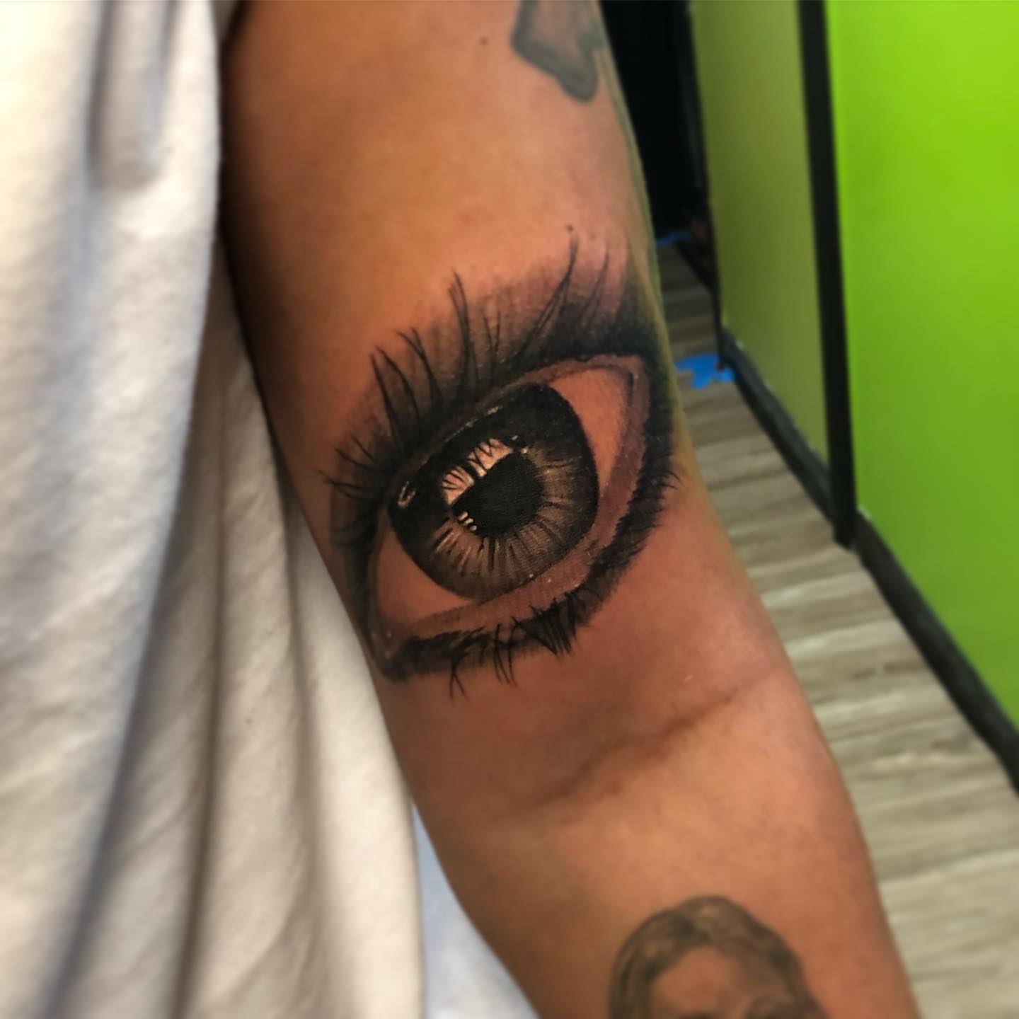 Eye realism tattoo on the forearm by Nick Jones (Buttonsandfaders)